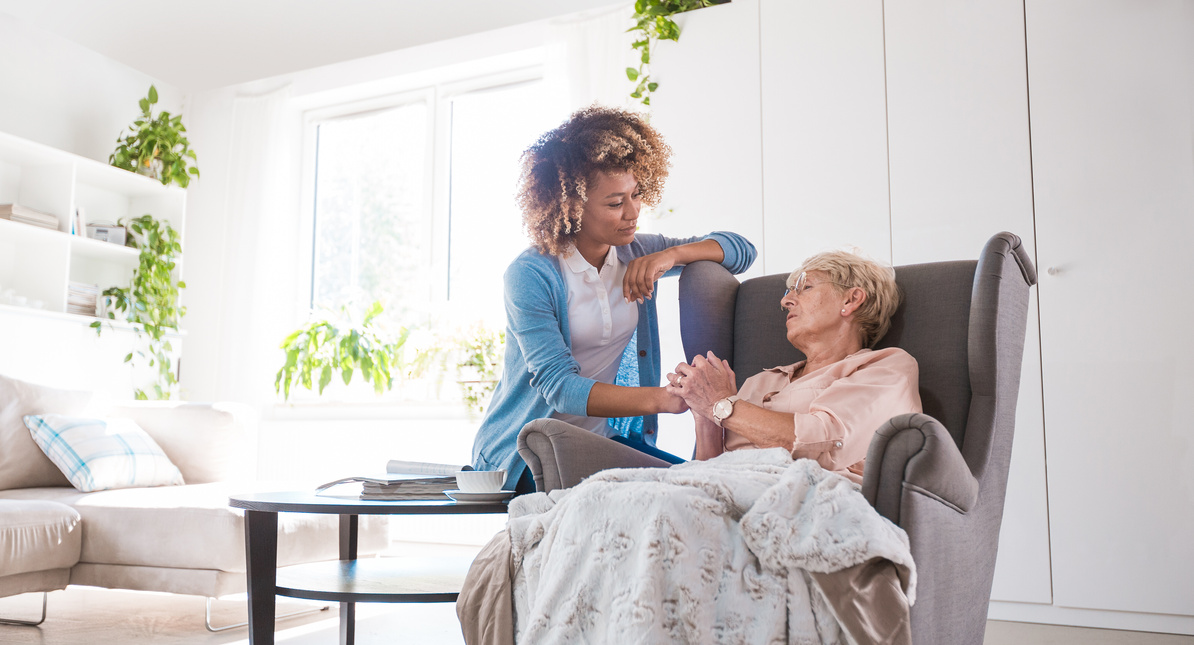 Home nurse taking care of an eldery lady